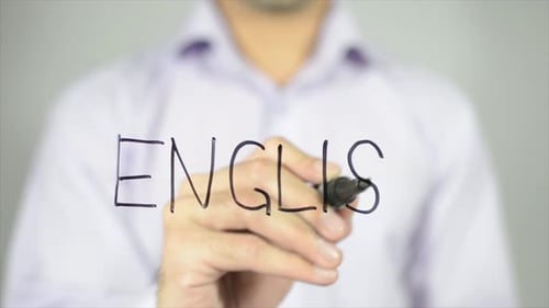 Man Writes the Word English on Clear Surface