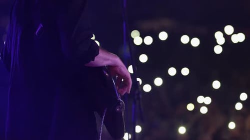 CloseUp of a Musician's Hands During Night Concert