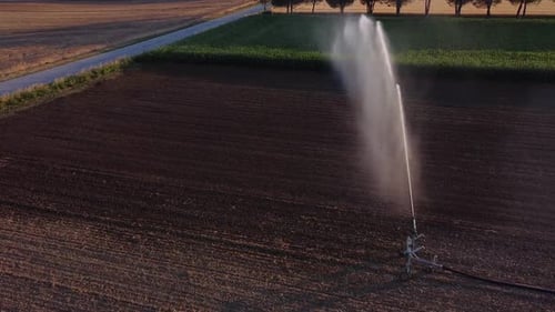 Aerial View of irrigation and Watering in the Middle of Agricultural Farmland Splashing Water