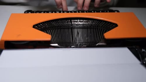 Writing letters with orange retro vintage typewriter