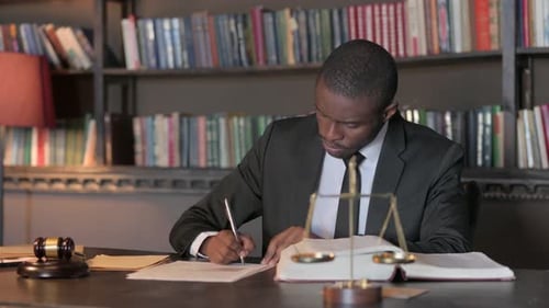 Pensive African American Lawyer Working on Legal Documents