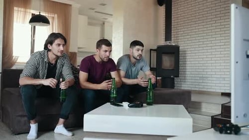 Three friends watching sport game by TV and feeling bad and depressed about lose