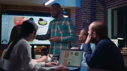 Diverse Team Having Business Meeting in Office at Night