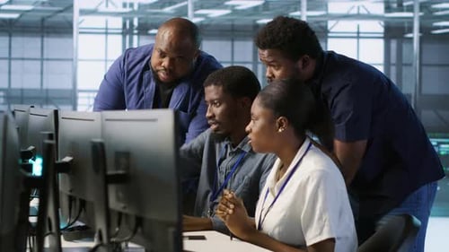 Team Discussing Project at Computer Workstation