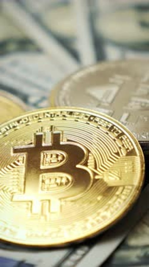 Bitcoin cryptocurrency. Golden bitcoins BTC rotating, top view. Vertical video