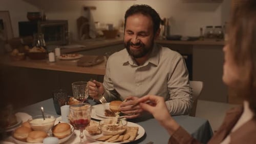 Friends and Family Gather Around Dinner Table