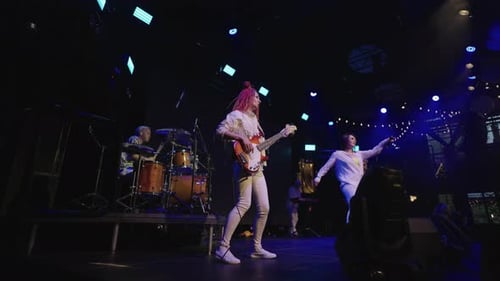 Pop Music Gig on Stage with Bright Neon Soffit Funny Energetic Musicians are Singing and Playing