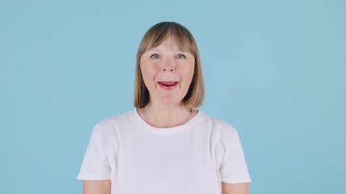 Woman Laughing and Smiling on Blue Background