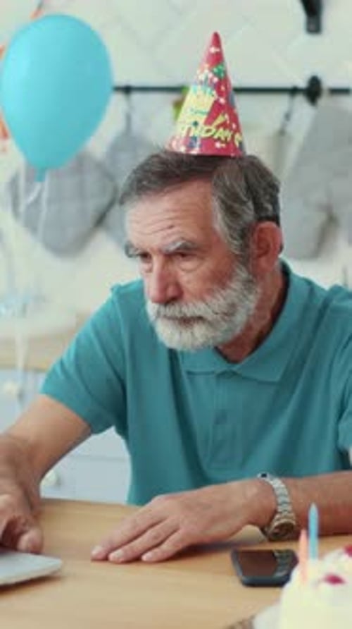 Senior Man Celebrating Birthday With Laptop