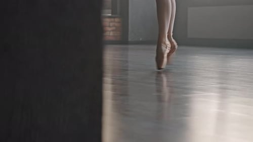 Elegant Ballet Dancer Practices Graceful Footwork in Studio