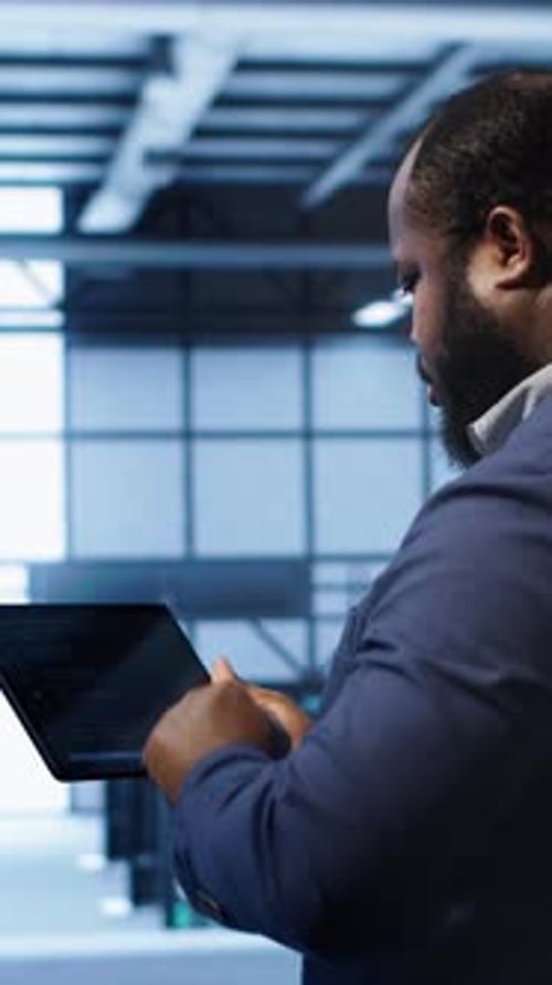 Vertical Video Engineer in Data Center Fixing Errors Affecting Server Rows Rigs