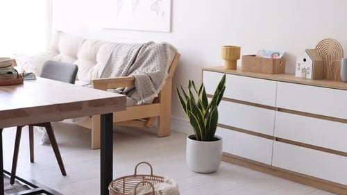 Bright Minimalist Dining Room Interior with Table and Couch