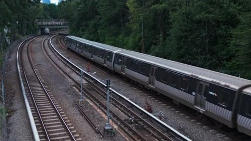 Aerial view of passing american metro on railroad in scenic area of Atlanta City during cloudy day -