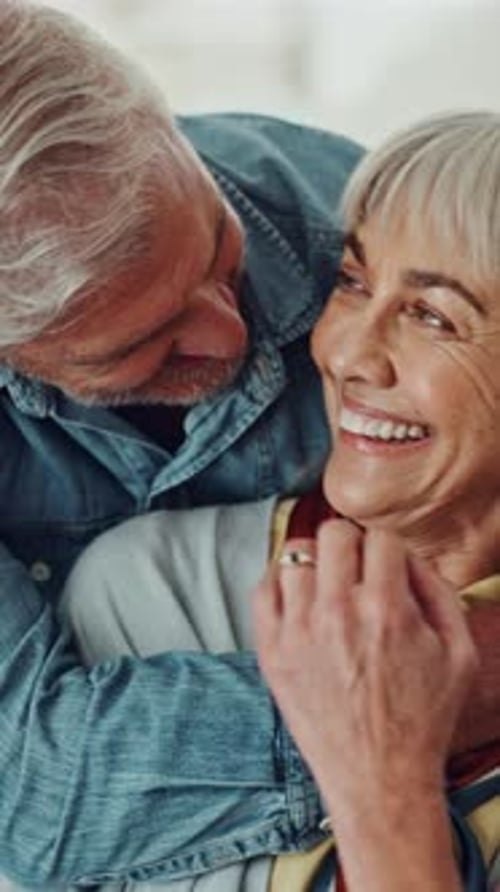 Loving Senior Couple Embracing Affectionately Indoors During the Day
