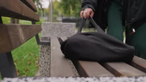 Woman Rests Outdoors Serene Woman on Park Bench Reflective Woman Seated on Park Bench Woman