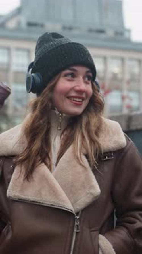 Woman in Shearling Jacket Playfully Swinging Umbrella on Autumn Street