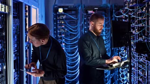 Server Room Technicians Working on Computer Systems