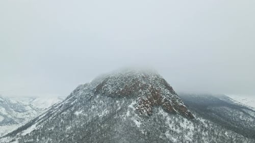 Aerial Flight Drone Landscape of Beautiful Mountains Snow Covered Cliff Rock Thick Foggy Clouds on