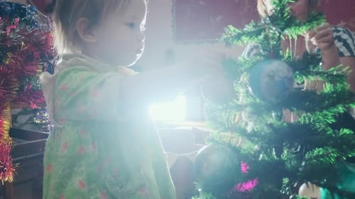 Child Decorating Christmas Tree with Family