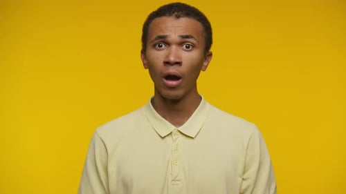 Surprised Man Looking Around on Yellow Background