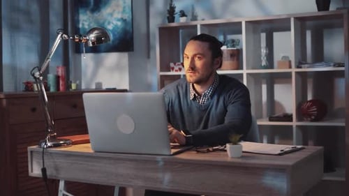 Dedicated and Focused Professional Engaging in Work From Home Office Utilizing Laptop