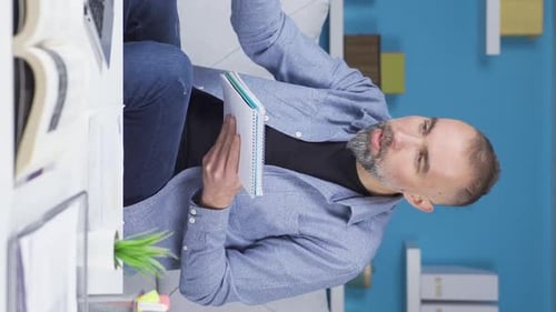 Vertical Video of Home office worker man making video call.