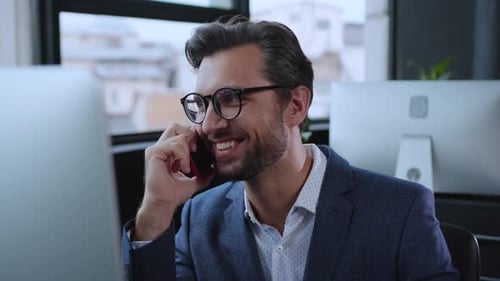 A Professional Man in a Modern Office Environment Making an Important Business Call