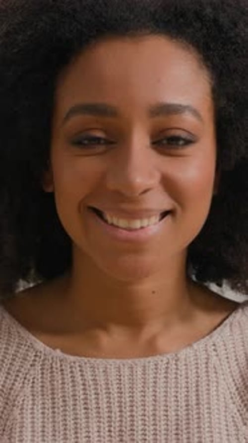 Smiling woman with curly hair close up portrait