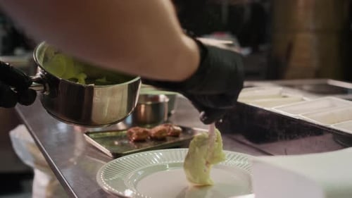 Chef Plating Mashed Potatoes at Restaurant Kitchen