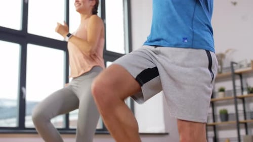 Sport, Fitness, Lifestyle and People Concept - Smiling Man and Woman Exercising