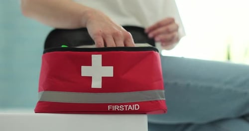 Person Taking Pills From First Aid Kit