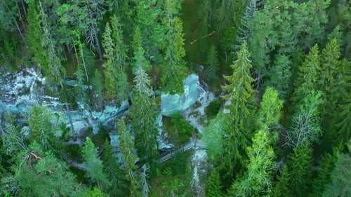 Aerial view of Sietiņiezis cliffs surrounded by dense forest in Valmiera Parish