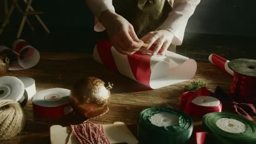 Wrapping Christmas Gift with Ribbons and Ornaments