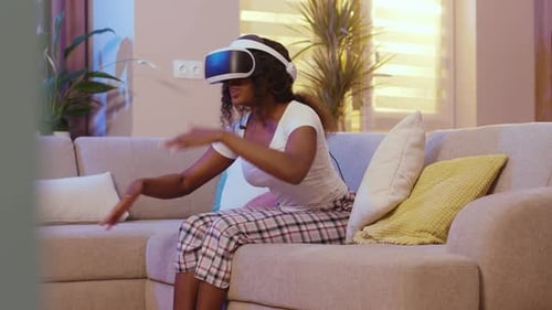 Woman Experiencing Virtual Reality Headset on Couch