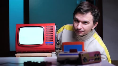 Man with Retro Gaming Console and Television