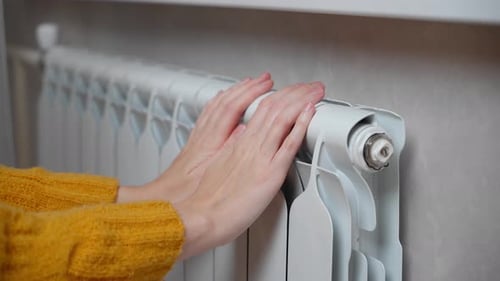 Warming Hands on a Radiator for Comfort