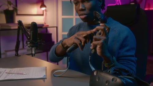 Excited Black Male Gamer Demonstrating VR Controllers on Live Stream