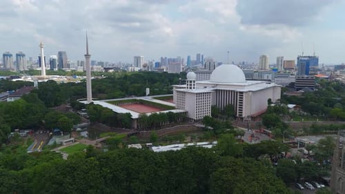 Jakarta, 01 July 2025, Aerial drone footage of Jakarta landmarks istiqlal mosque background monument