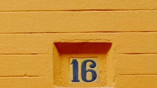 Number 16 (sixteen) Affixed to a Building