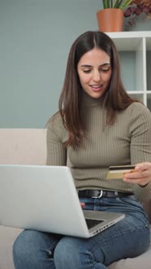 Woman Shopping Online with Credit Card on Couch