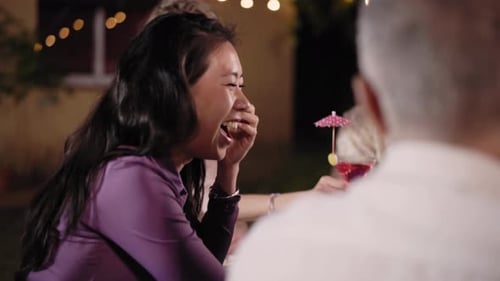 Friends Laugh and Chat at Outdoor Evening Gathering