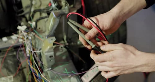 Mechanic Repairing Electrical System In Car Service