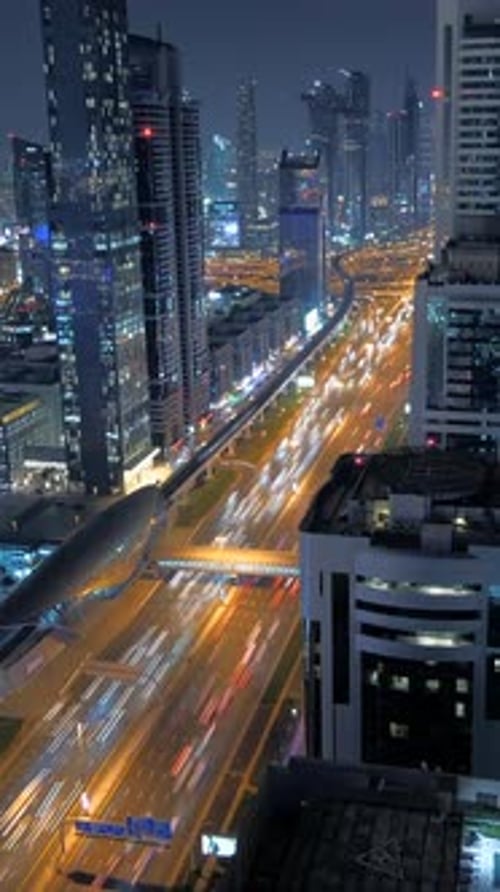A City at Night Adorned with Vibrant Light Trails Illuminating Tall Skyscrapers and Buildings