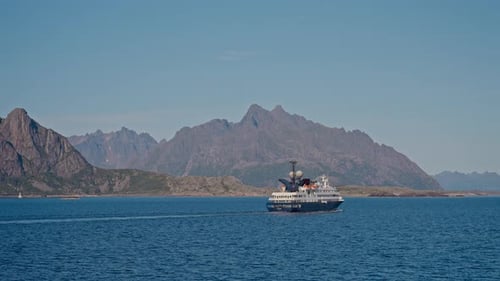 Ferry's Journey Against Rugged Mountain Backdrop