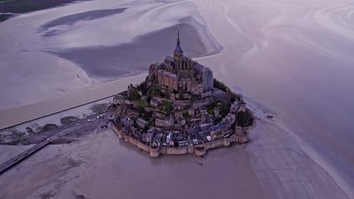 Aerial view of historic abbey and church on island, France.