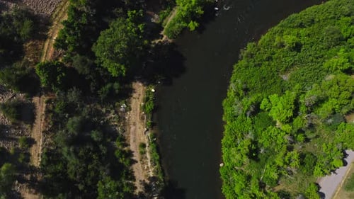 Erratic aerial over tubers on a flowing river.