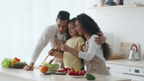 Family Cooking Together in a Bright Kitchen Preparing a Healthy Meal