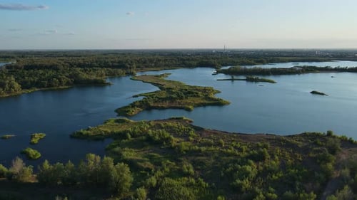 Beautiful Landscape in Aerial Drone Shot Forest Woods and Calm Tranquil Lake Clear Blue Sky High