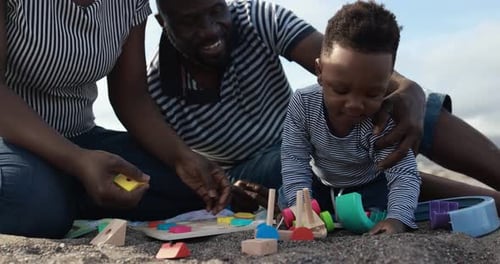 African family enjoying beach fun with their little son in South Africa