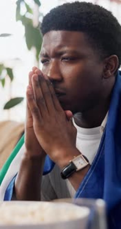 Young Man Covers Face in Disappointment Indoors